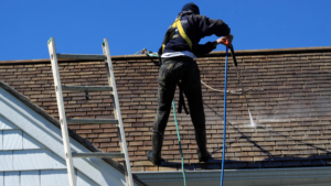 man cleaning roof