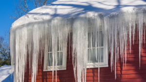 Icicles hanging off snowy roof