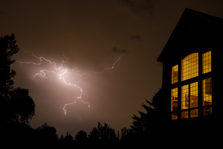 Crackling lightning near the window of a residential home in the Midwest